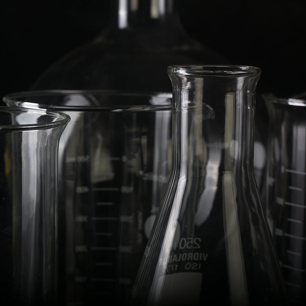 Beaker glass jars for skincare creation in a lab.